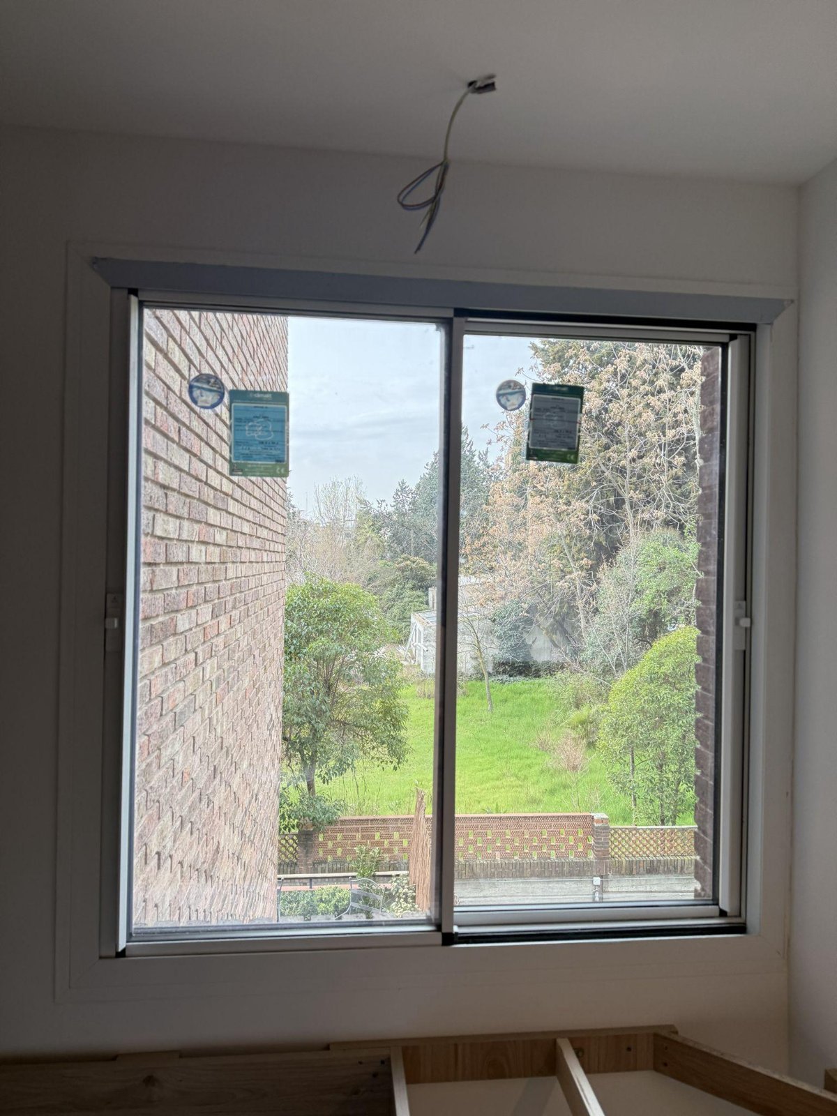 Corredera minimalista Cortizo Cor Vision con vistas a jardín en vivienda de Madrid